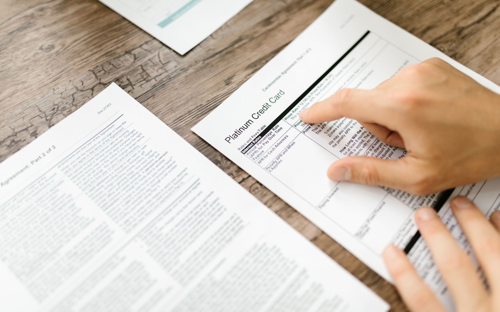 A printed Kennel Club breed standard document open on a desk, the text legible, a hand resting beside it